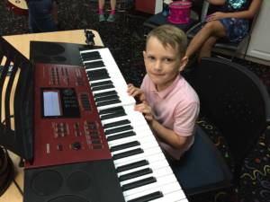 happy student taking piano classes in Miami