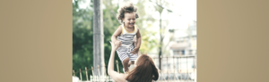 red haired woman playing with a baby