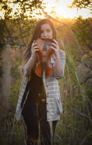 Tampa Violin Teacher holding violin upside down Barrett Music School
