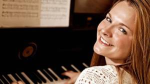 woman sitting at the piano and smiling